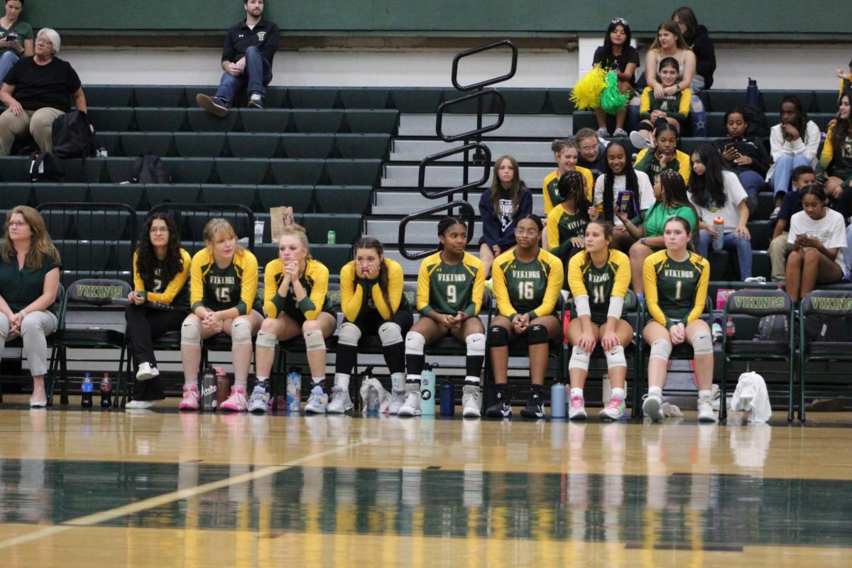 The volleyball team watching the game unfold.