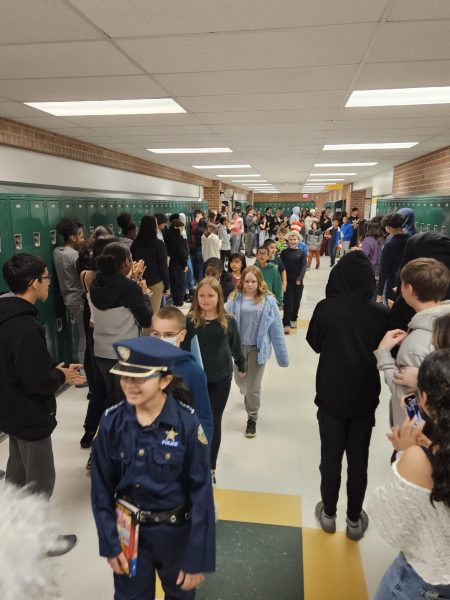 OBES students parading through the halls surrounding by cheering WSHS students